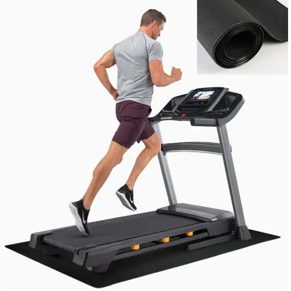 Treadmill placed on a black shock-absorbing equipment mat