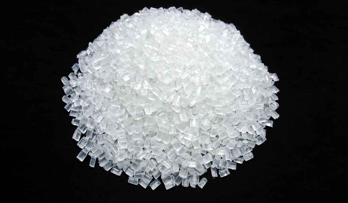 uwin-resin-pellets-no-watermark-1200x700 Close-up of translucent material pellets on a black background.