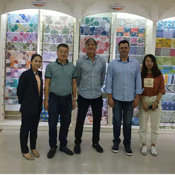 Uwin team and business partners in front of custom mat displays at an exhibition