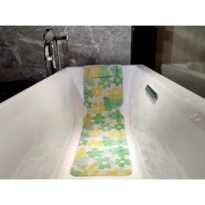 Green and yellow floral bath mat extending along the base and backrest of a white bathtub.