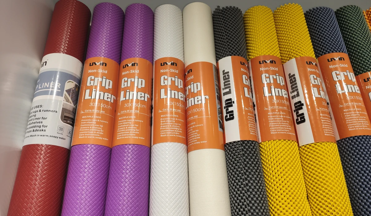 Uwin shelf liner rolls in assorted colors, featuring embossed surfaces and open mesh textures with retail packaging.